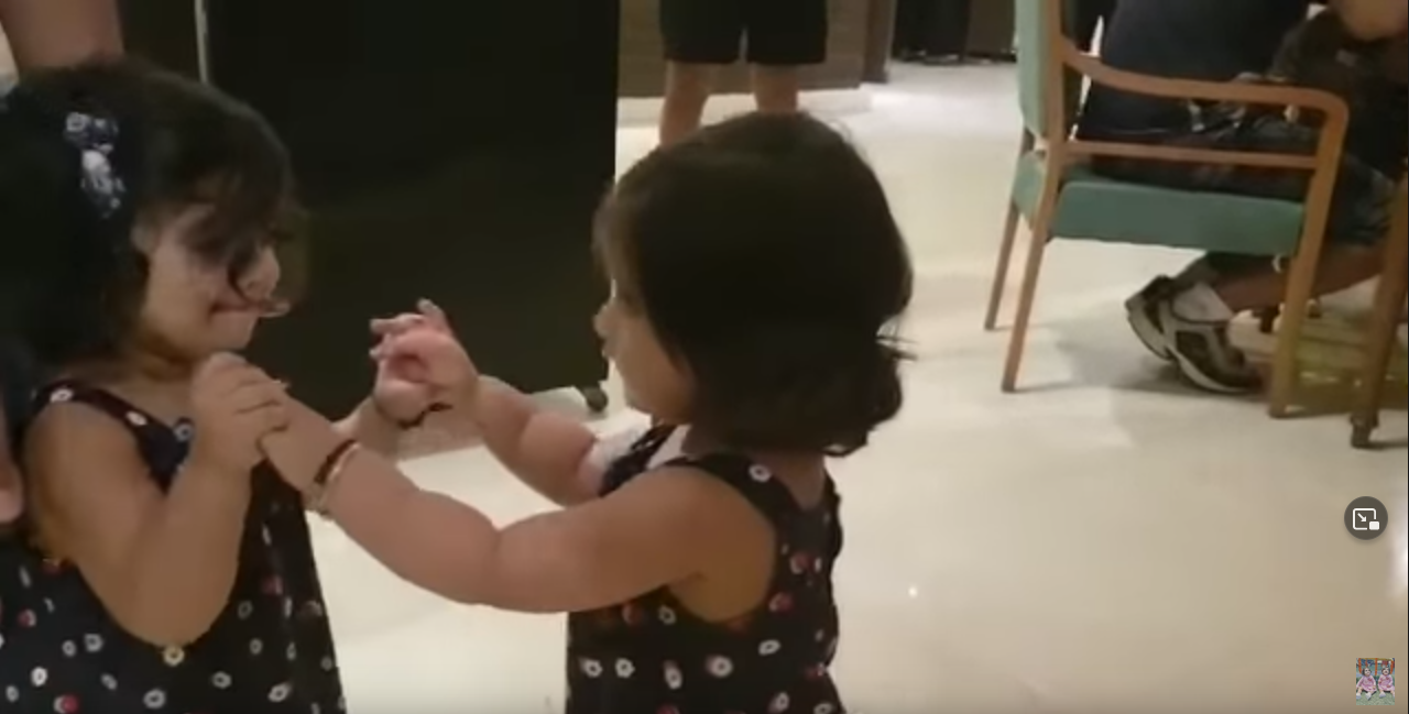 Twins Bella and Vienna hugging for the first time